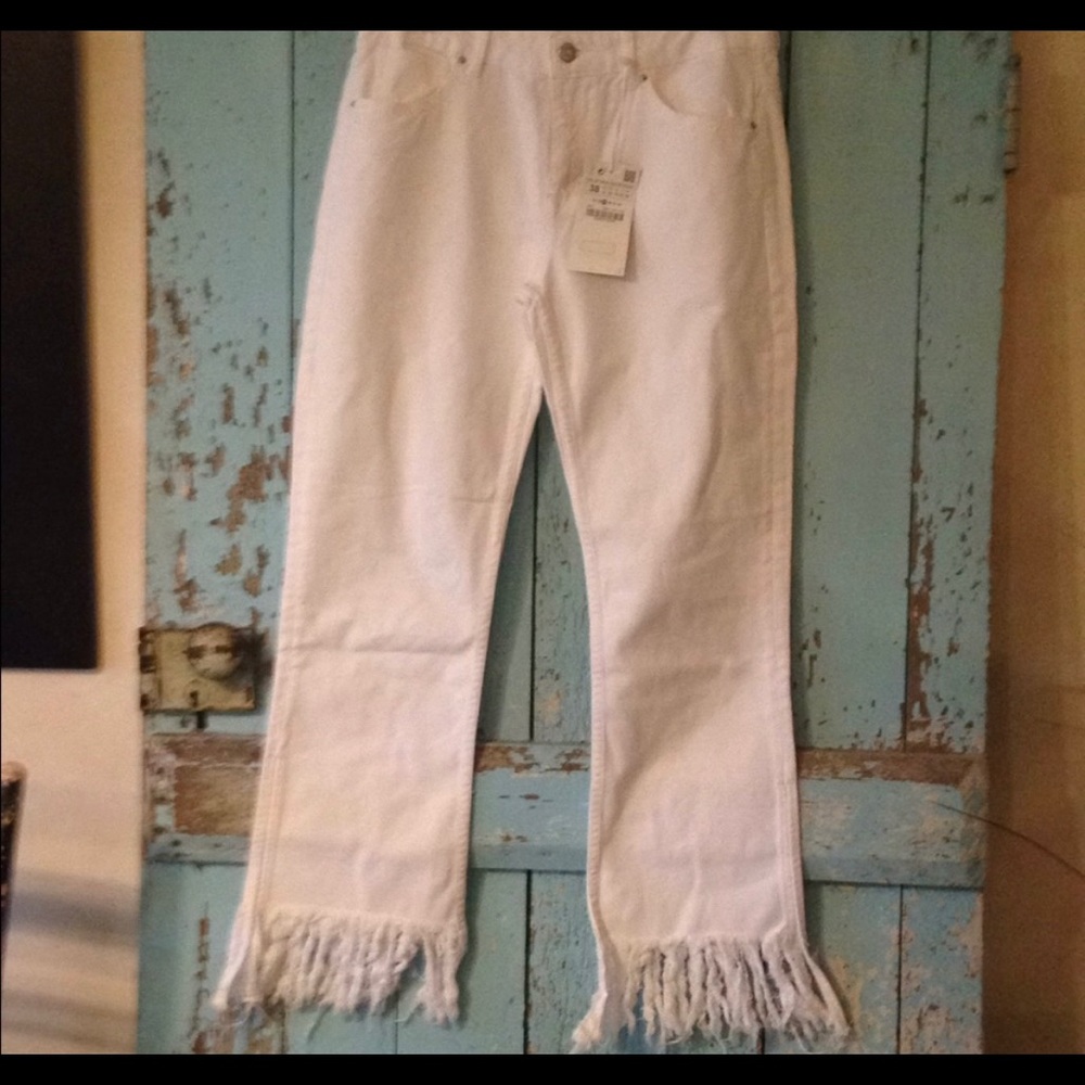 Super cute White Zara jeans with fringe bottoms